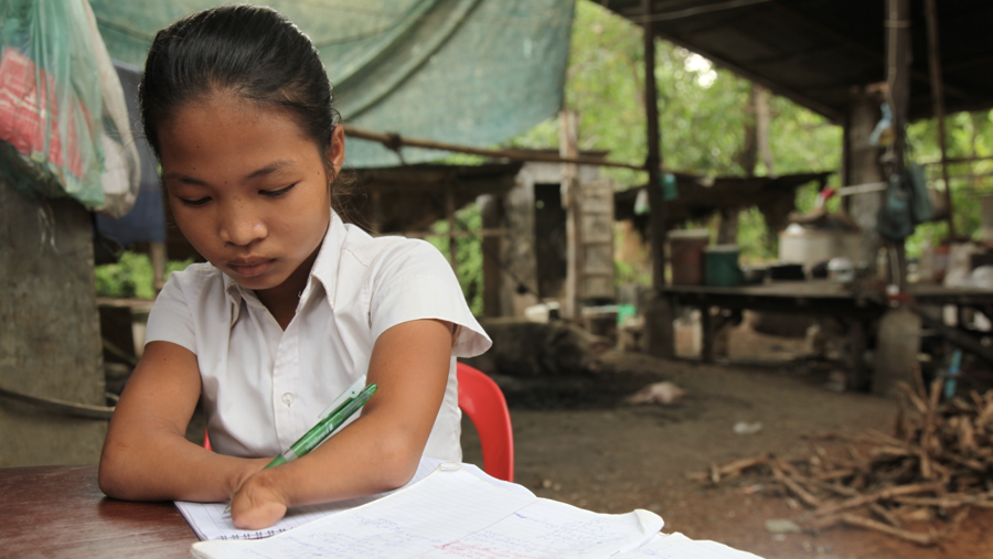 Cambodia: 14 year old, Un Kosal, born with shortened forearms and no hands does not let her disability prevent her from aspiring to be a teacher. In Kampong Thom province disability-inclusive education and WASH facilities at Korsal's primary school enabled her to graduate and she now attends secondary school. ©UNI180578/Galli
