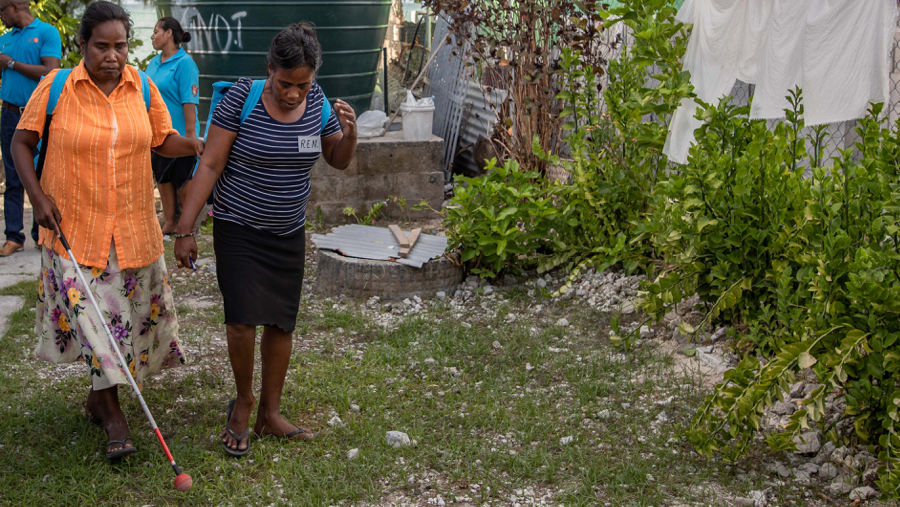 Photo of a blind in woman in Kiribati being helped by UNFPA local partners. Carley Learson