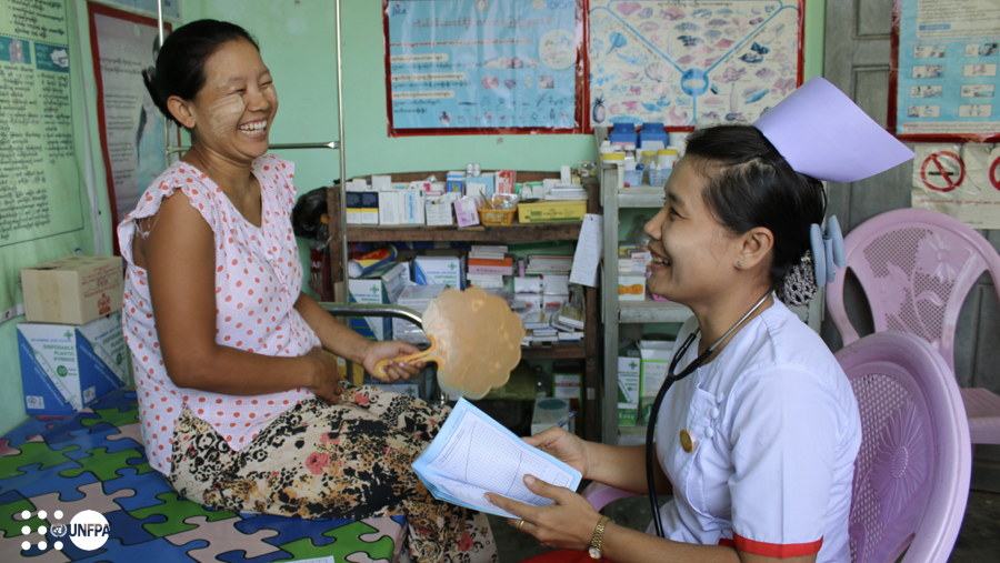 Myanmar: A midwife shares a laugh with an expecting mother at an antenatal consultation in Ayeyawady. Only 60% of births in 2021 were attended by a skilled birth attendant so more needs to be done to train, mentor, deploy and distribute more SRMNAH health workers to the country’s hard-to-reach areas. ©UNFPA/Nowai Linn 