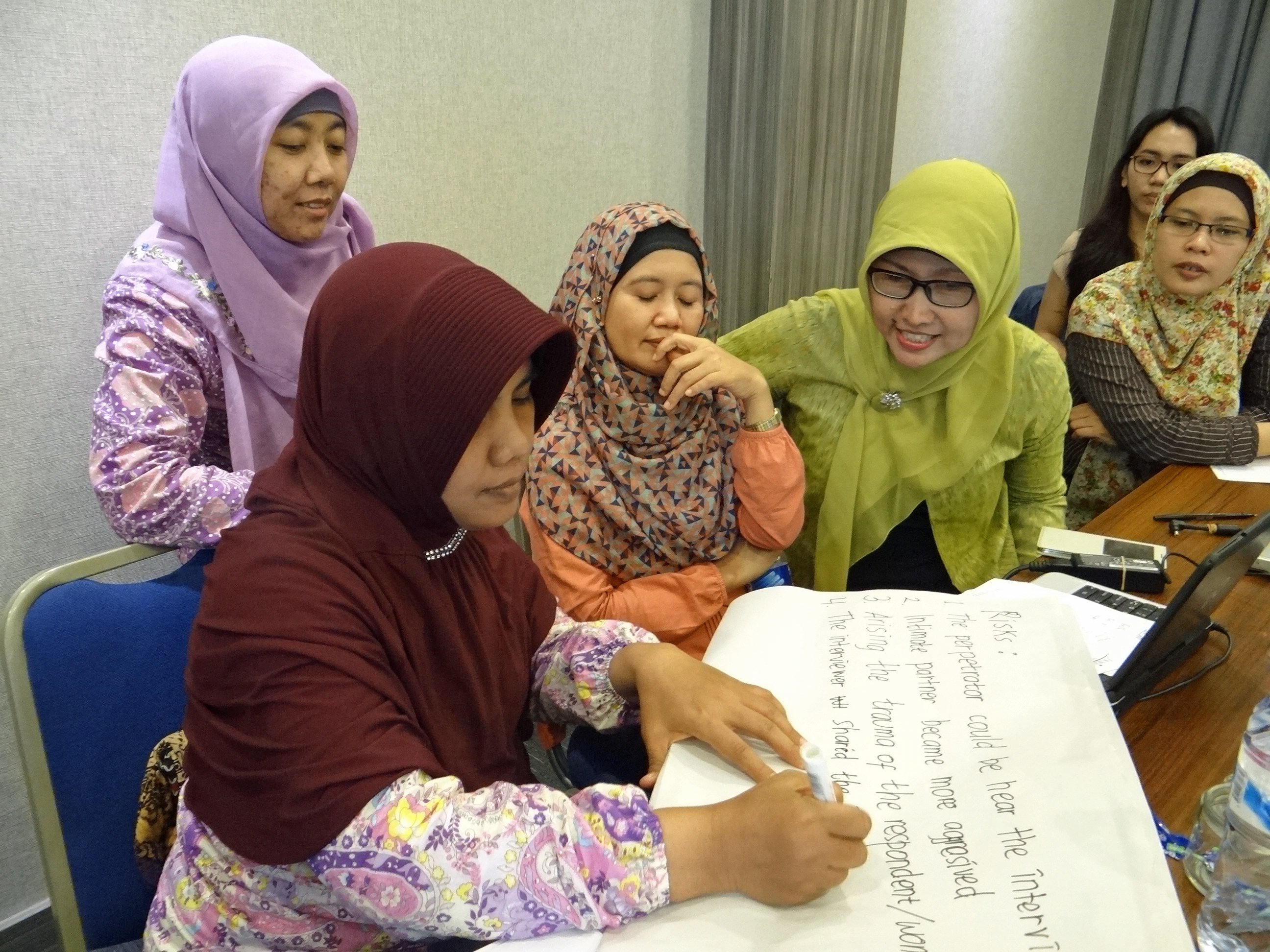 Women work as part of a violence against women data collection training