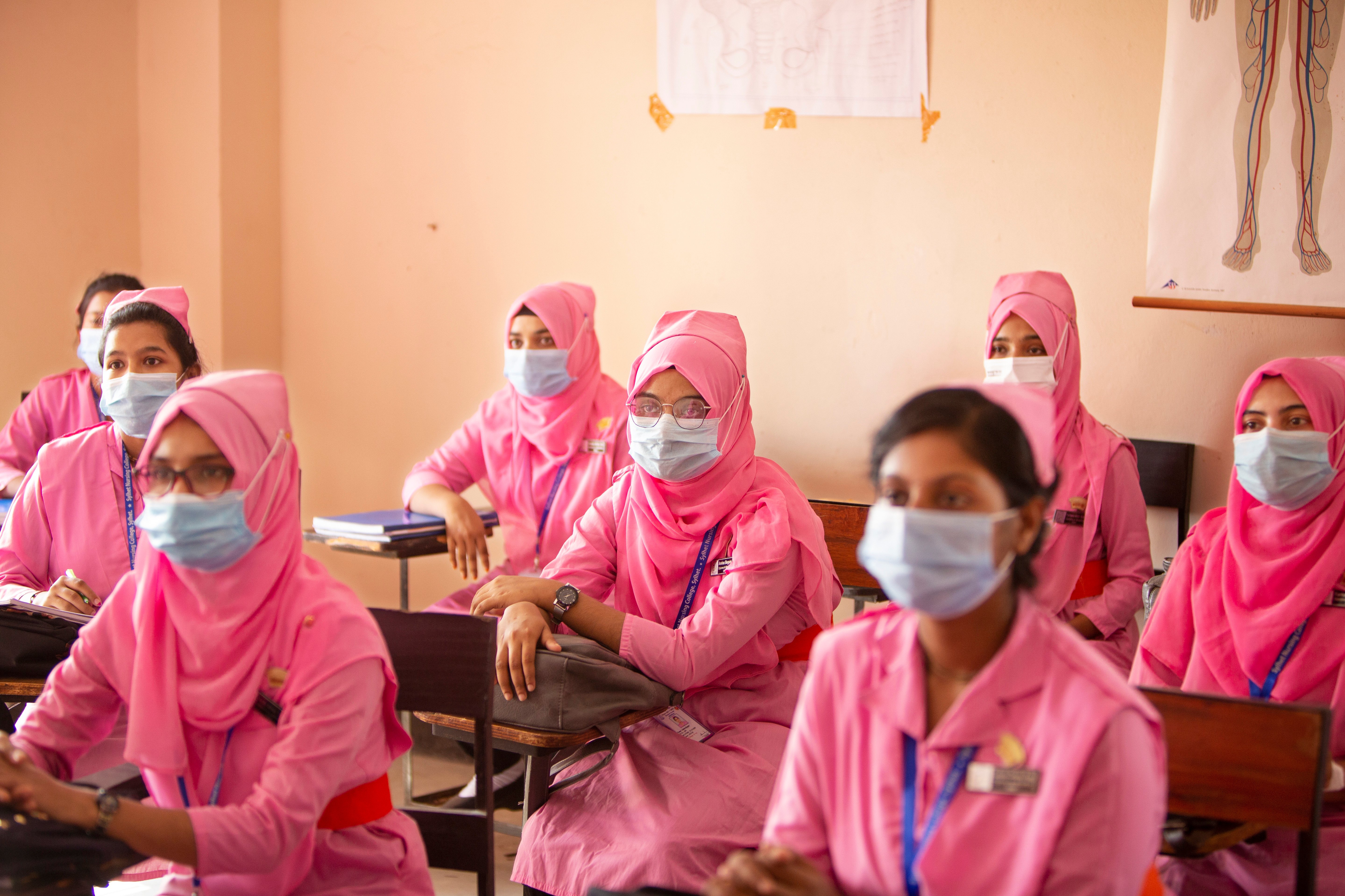 Photo of a classroom of midwife students dressed in pink uniforms in Bangladesh