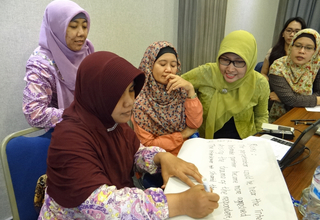 Women work as part of a violence against women data collection training