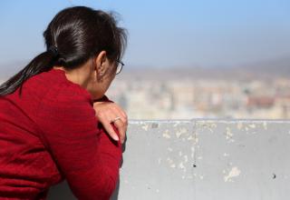 A woman looks out over the landscape in Mongolia