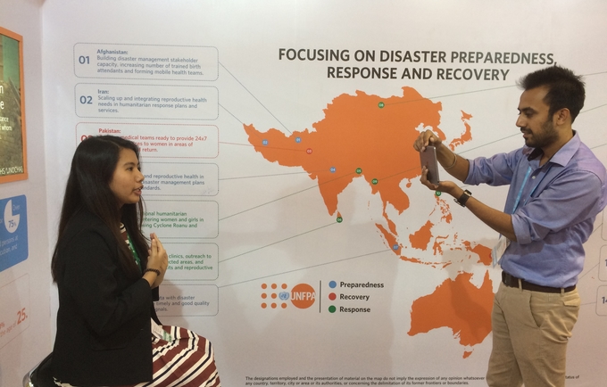 Chloe Reynaldo being interviewed at the UNFPA AMCDRR stall