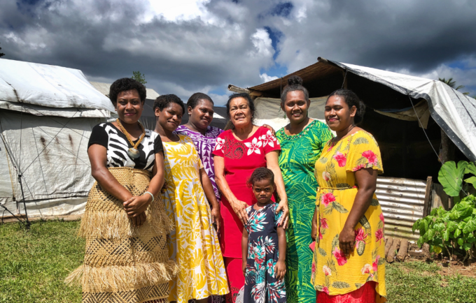 Retired midwife Suliana Batikawai (red dress, middle) who supported the mothers and girls of Nabavatu Village in the aftermath o