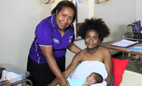 Sr Mary Sitiang celebrates new delivery with healthy mother and baby in Port Moresby General Hospital.