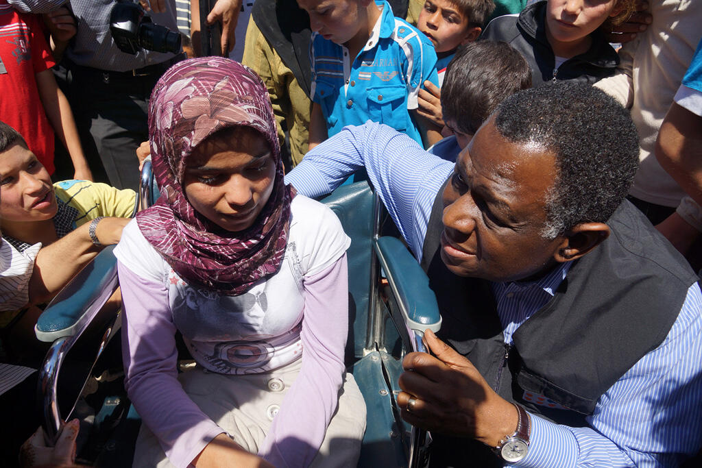 UNFPA Executive Director, Dr. Babatunde Osotimehin, with a Syrian teenage girl with special needs at the Nizip Camp in Turkey. Photo: UNFPA/Nezih Tavlas