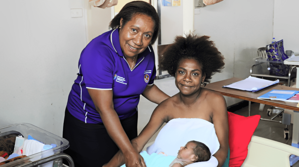 Sr Mary Sitiang celebrates new delivery with healthy mother and baby in Port Moresby General Hospital.