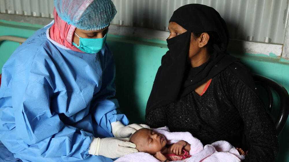 A midwife attends to a mother and her newborn at a health facility in Cox's Bazar, Bangladesh (Photo: UNFPA/Fahima Tajrin)