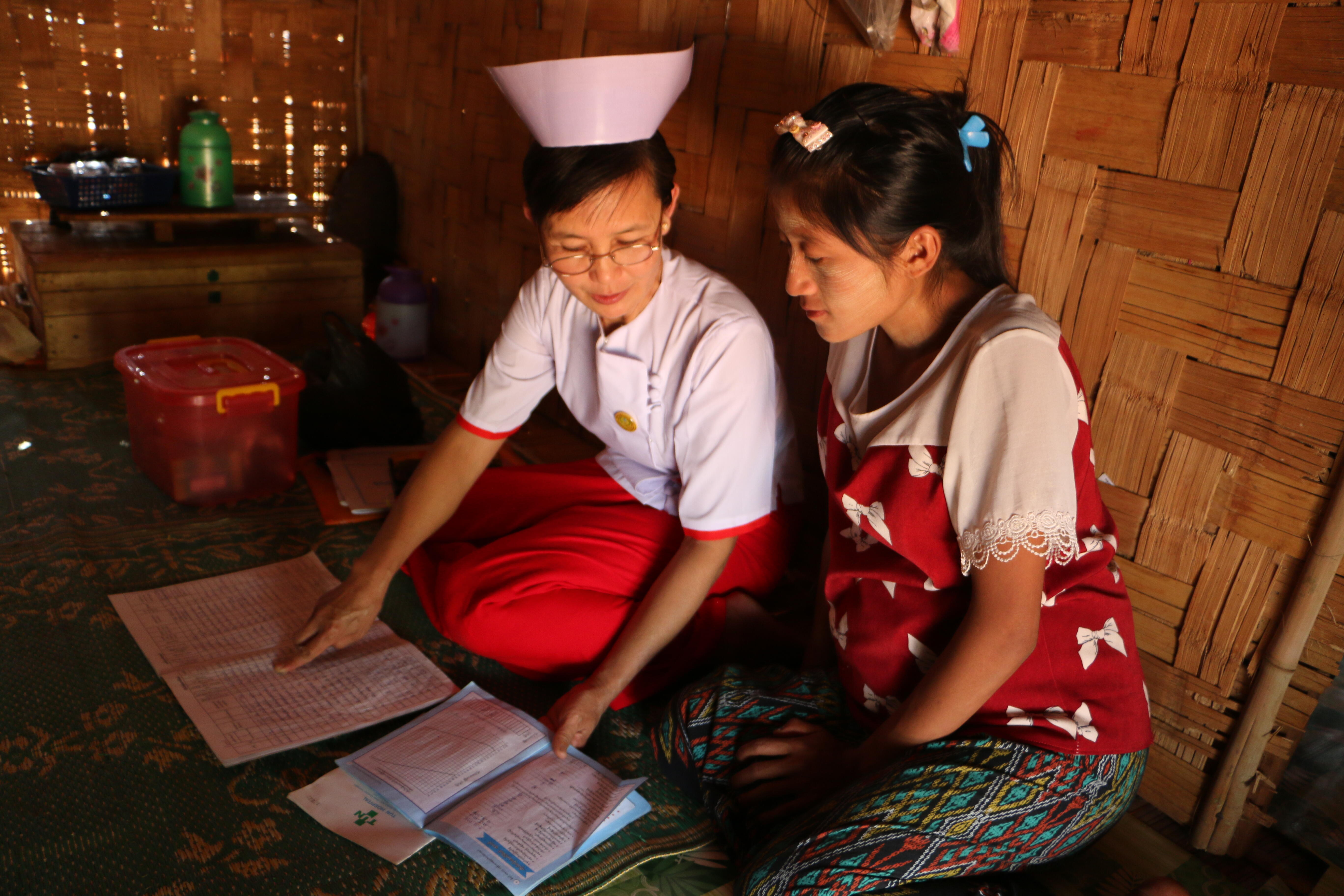 Midwife Nan Mya Phyu discusses family planning with Nan Aye Aye Han in Nam Khoke Village, Shan State, Myanmar