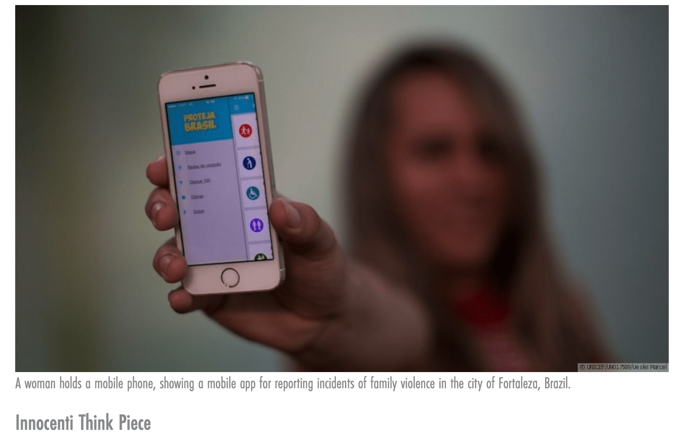 A woman holds a mobile phone, showing a mobile app for reporting incidents of family violence in the city of Fortaleza, Brazil. 