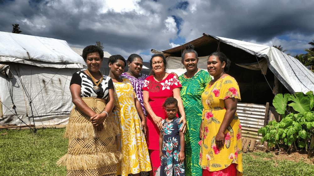 Retired midwife Suliana Batikawai (red dress, middle) who supported the mothers and girls of Nabavatu Village in the aftermath o