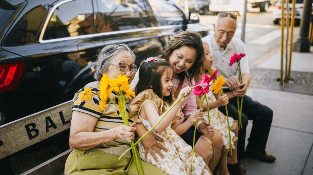 A happy family with grandparents, a mother, and a daughter