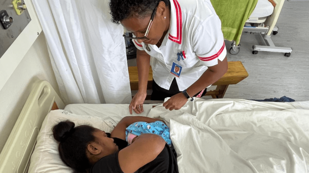 At Makoi Maternity Centre on the outskirts of Suva, Fiji, a midwife attends to a mother who has just given birth