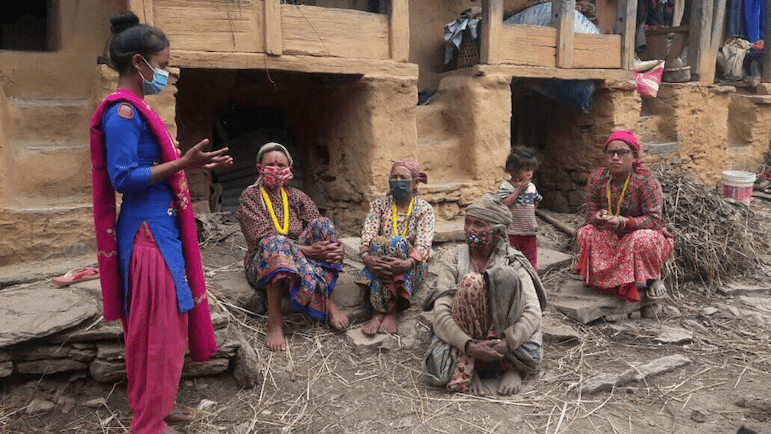 Shilpa Sunar talks with women in her community about COVID-19 and issues facing adolescent girls | Image: UNFPA Nepal