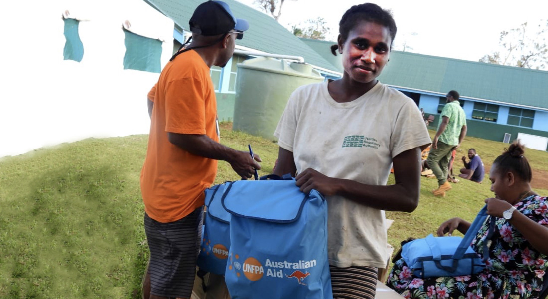 At the evacuation centre in Epau, a team from the Department of Women's Affairs distributes Dignity Kits to women and girls. ©UNFPA Pacific
